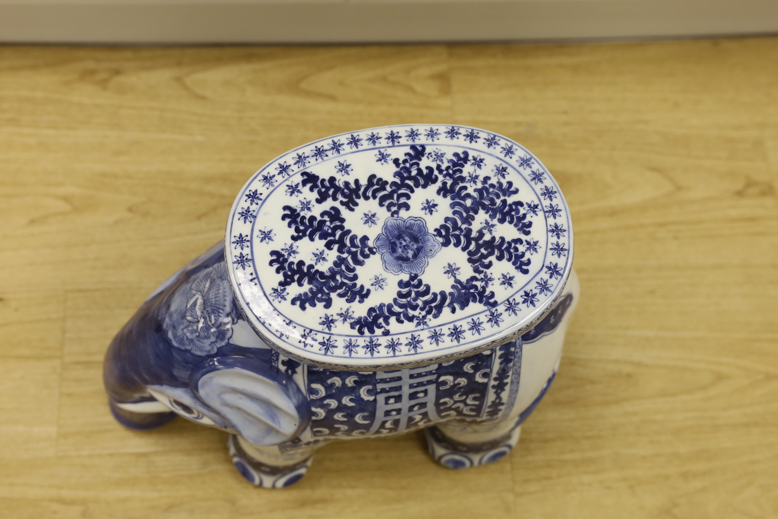 A porcelain conservatory seat in the form of an elephant in a Chinese style, 37cm high